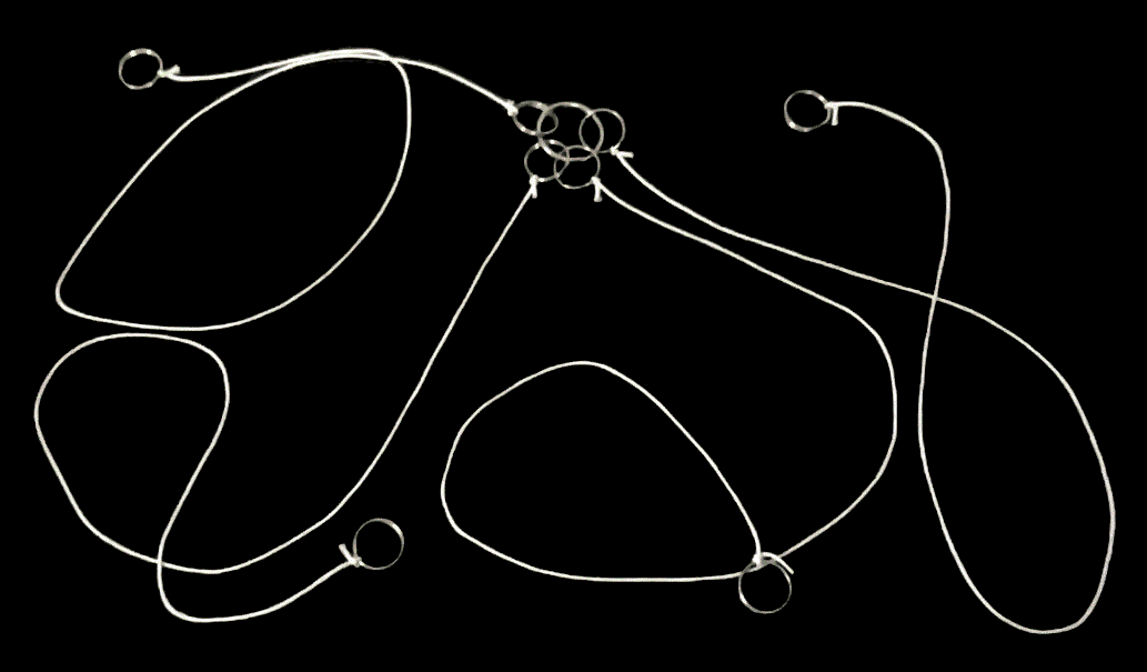 four strings, connected to a ring, on a black background
