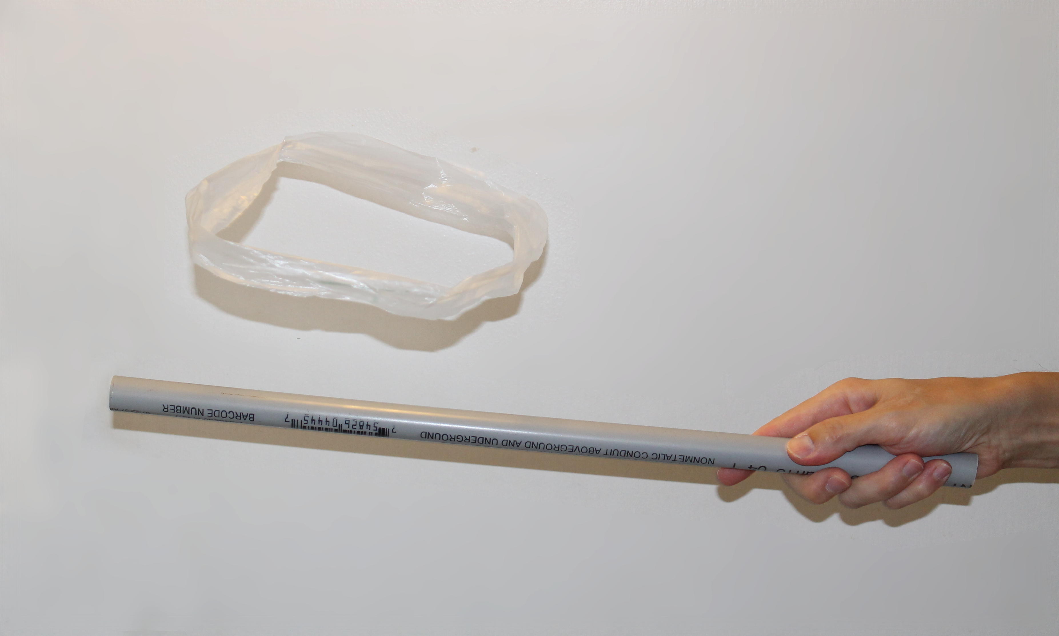 A plastic bag being 'levitated' by a charged PVC pipe